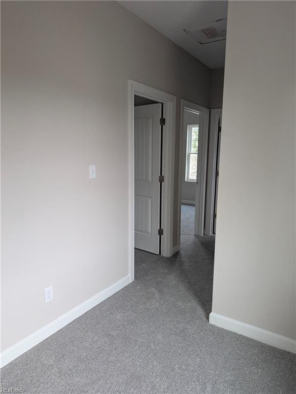 carpeted spare room with baseboards