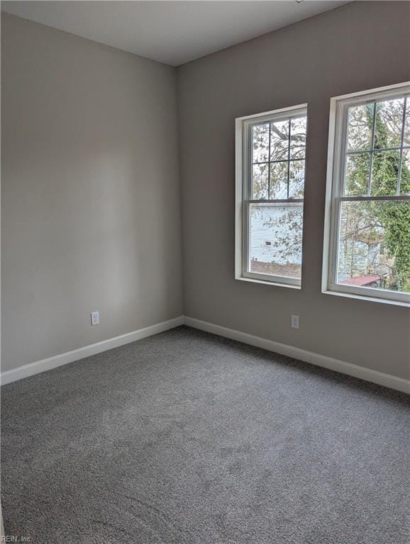 carpeted empty room with baseboards