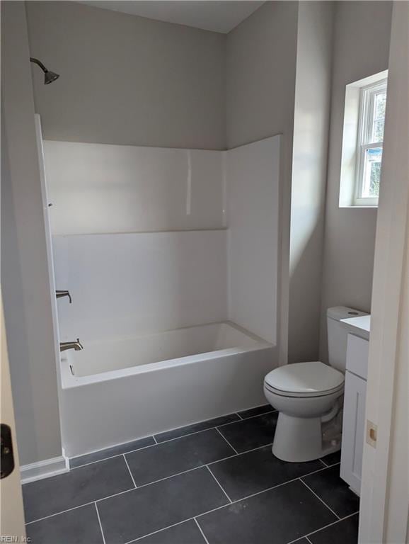 full bath with tile patterned flooring, shower / washtub combination, toilet, and vanity