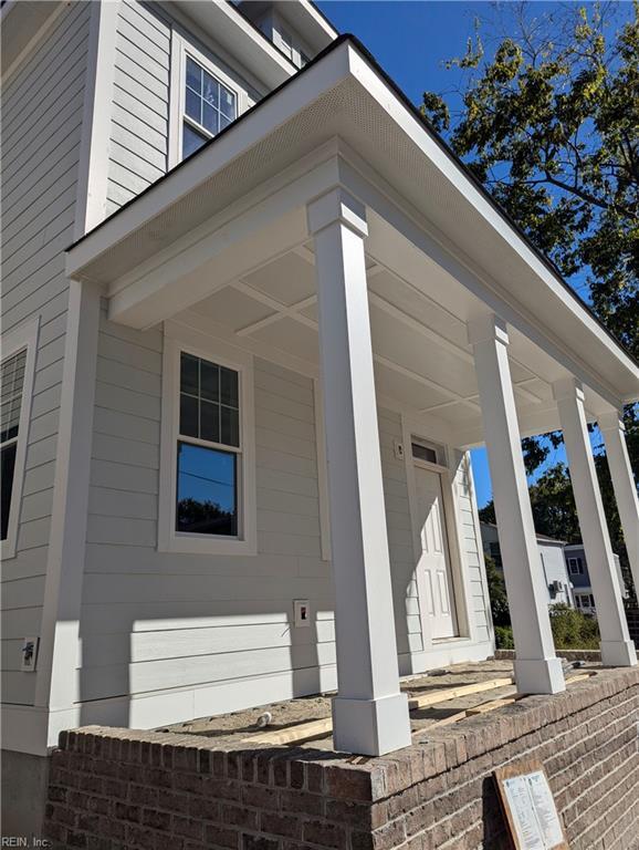 view of side of home with covered porch