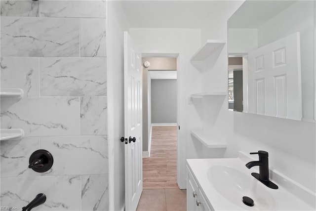 bathroom featuring vanity, a shower, and tile patterned flooring