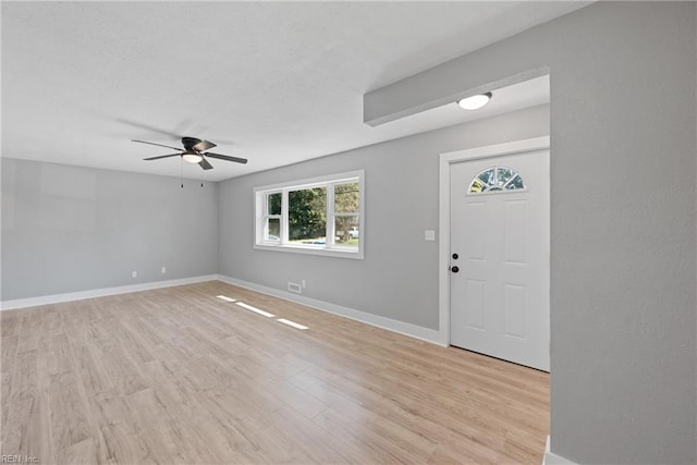 foyer entrance with light wood-type flooring and ceiling fan