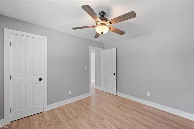 spare room with light wood-type flooring and ceiling fan