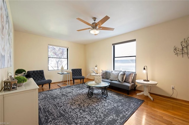 living room featuring ceiling fan and wood-type flooring