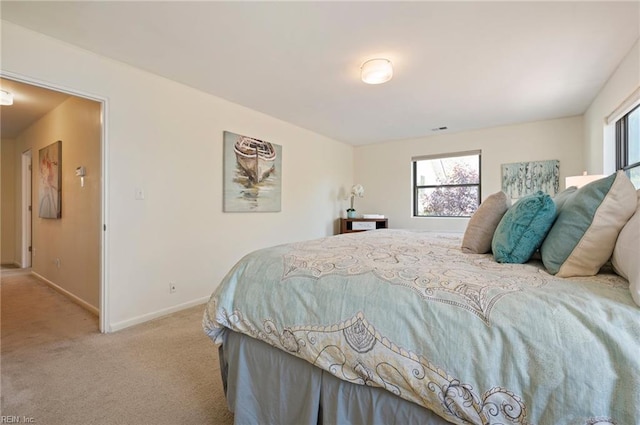 bedroom featuring light colored carpet