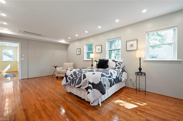 bedroom featuring multiple windows and hardwood / wood-style flooring