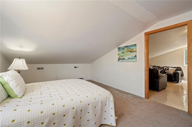 bedroom featuring carpet and vaulted ceiling