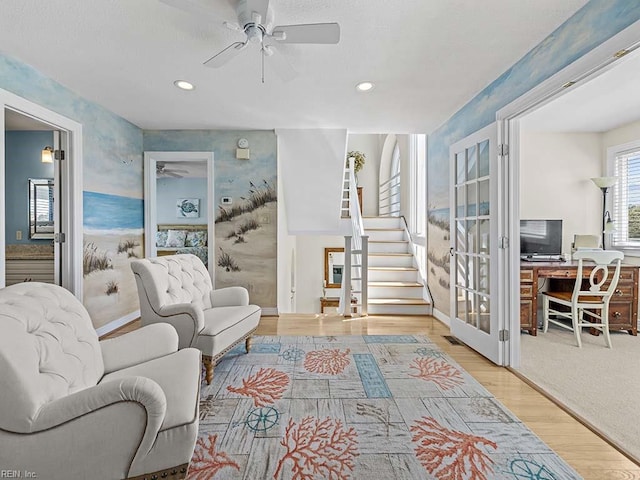 living room with ceiling fan and light hardwood / wood-style floors