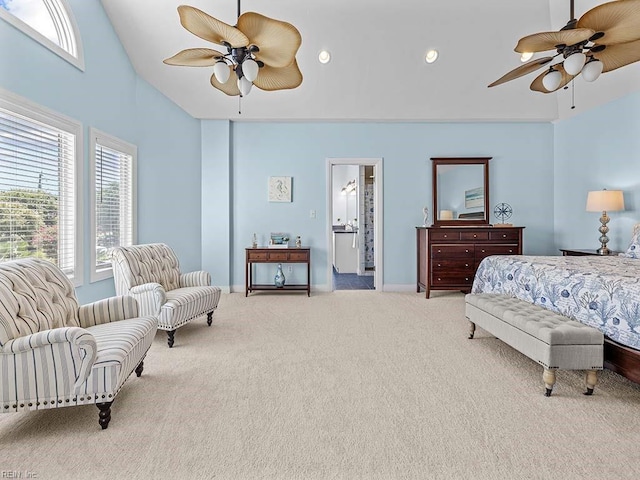 carpeted bedroom featuring ceiling fan, vaulted ceiling, and connected bathroom