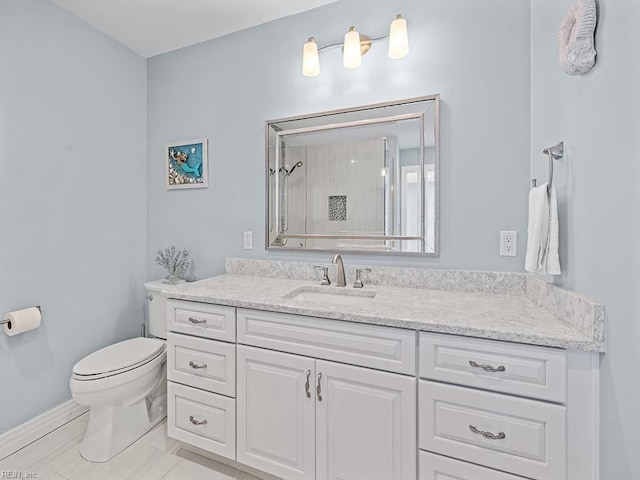 bathroom featuring vanity, toilet, and walk in shower