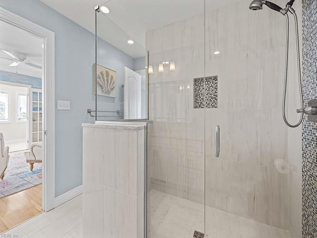 bathroom featuring hardwood / wood-style floors, an enclosed shower, and ceiling fan