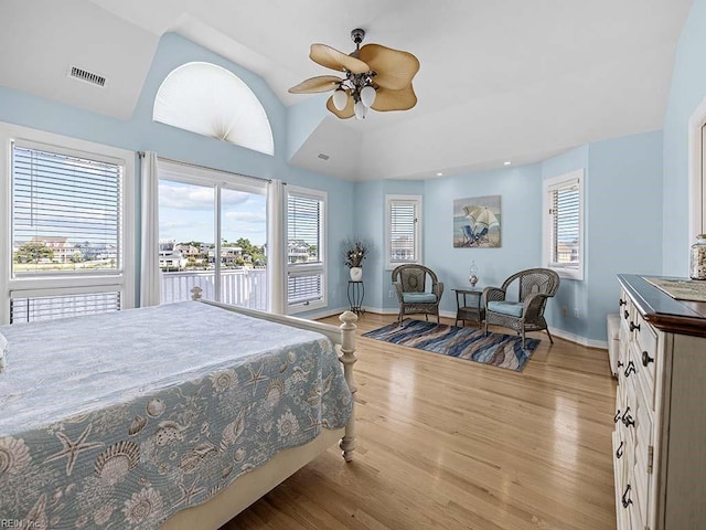 bedroom with multiple windows, ceiling fan, access to outside, and light hardwood / wood-style flooring