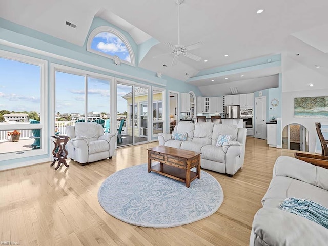 living room featuring high vaulted ceiling, ceiling fan, and light hardwood / wood-style flooring