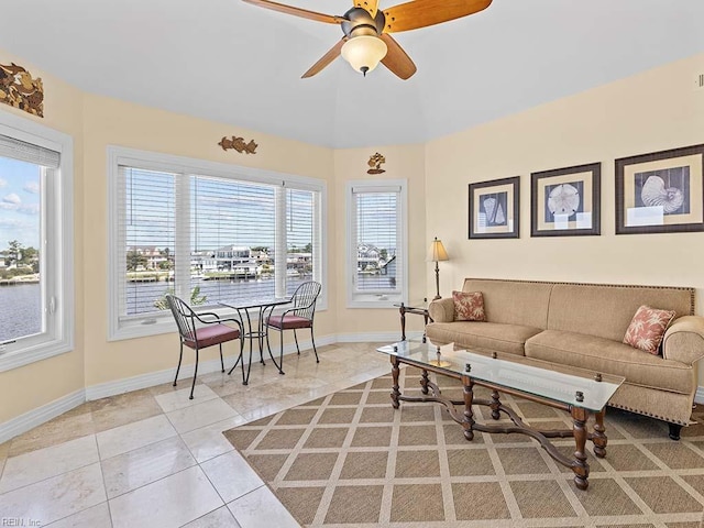 living room featuring ceiling fan and light tile patterned floors