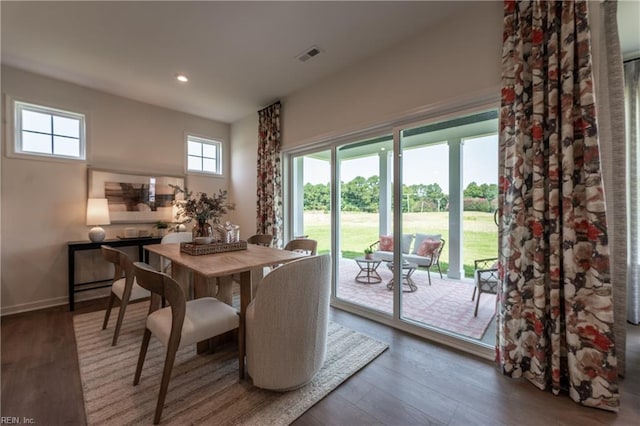 dining space with dark hardwood / wood-style flooring