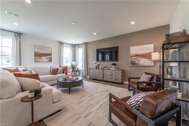 living room with light hardwood / wood-style flooring and a wealth of natural light