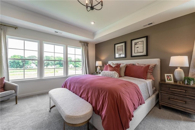 bedroom featuring crown molding, carpet flooring, a chandelier, and a raised ceiling