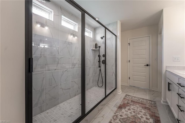 bathroom with a shower with door and vanity