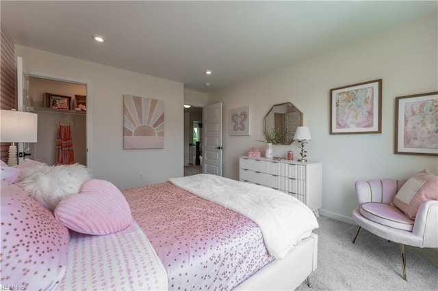 carpeted bedroom with a closet and a walk in closet