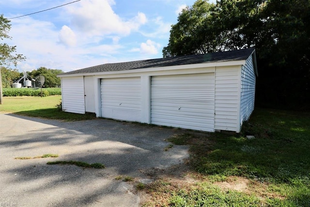 garage featuring a lawn