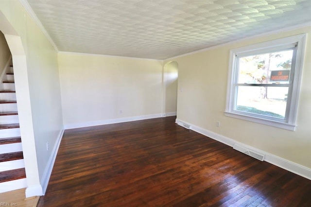 spare room with crown molding and dark hardwood / wood-style floors