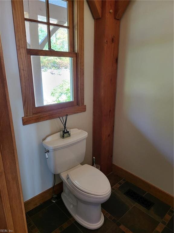 bathroom with toilet and tile patterned floors