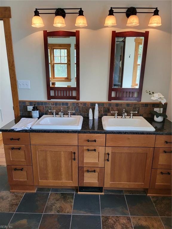 bathroom featuring vanity and tasteful backsplash