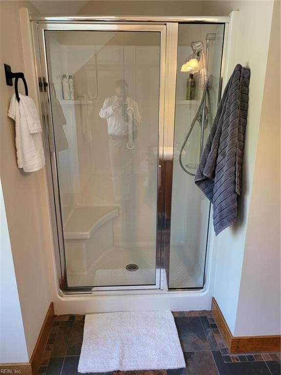 bathroom featuring tile patterned flooring and a shower with shower door