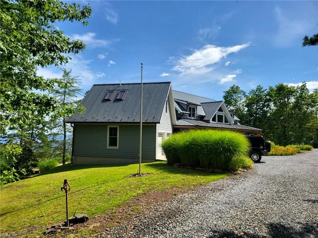 view of side of home with a lawn