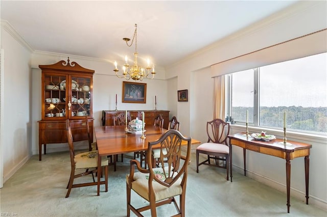 dining room featuring an inviting chandelier, light colored carpet, and ornamental molding