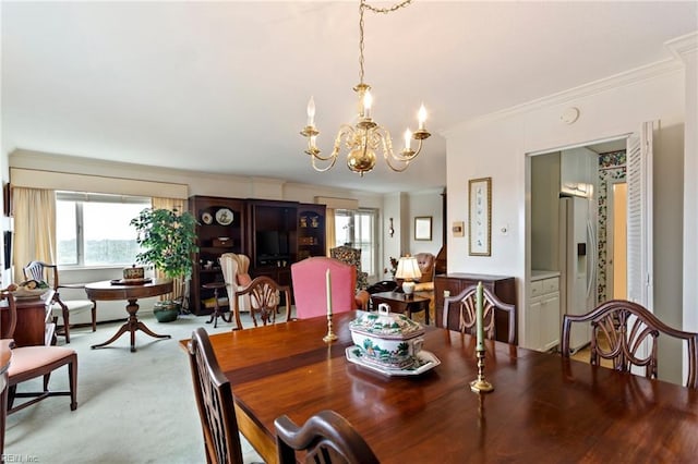 dining room featuring a notable chandelier, ornamental molding, and light carpet