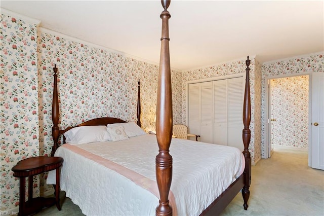 bedroom featuring ornamental molding, a closet, and carpet flooring