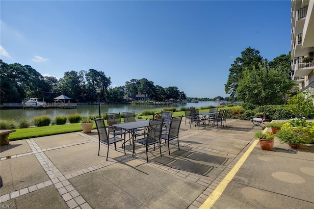 view of patio featuring a balcony and a water view