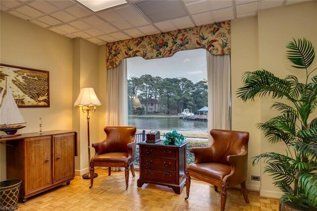 dining space featuring a paneled ceiling and light hardwood / wood-style flooring