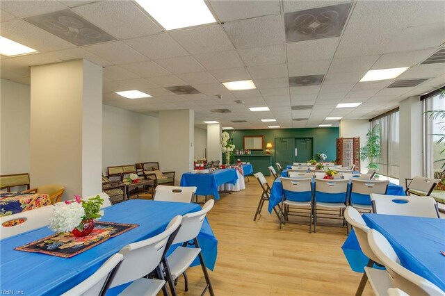 interior space with a drop ceiling and light hardwood / wood-style floors