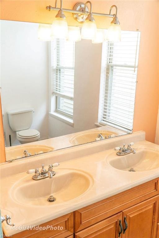 bathroom featuring vanity and toilet