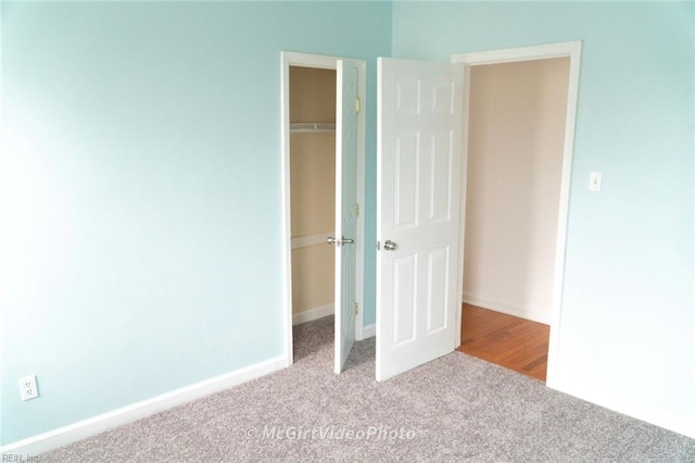 unfurnished bedroom with light carpet and a closet