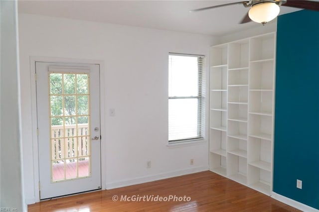 doorway with hardwood / wood-style floors, ceiling fan, and plenty of natural light