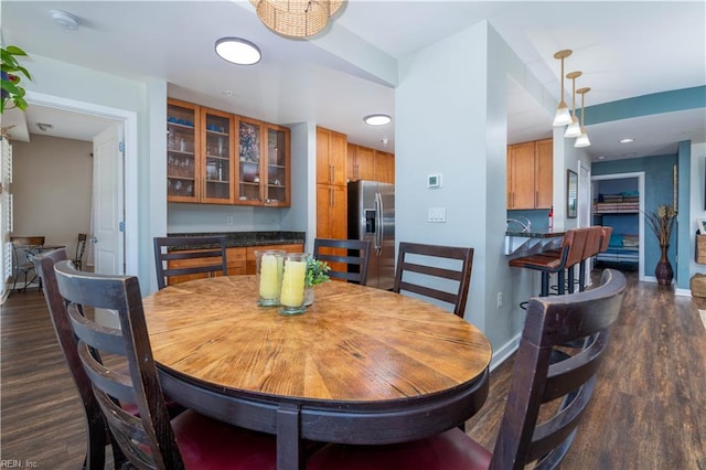 dining space with dark hardwood / wood-style flooring