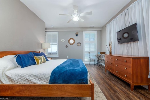 bedroom with dark hardwood / wood-style floors and ceiling fan