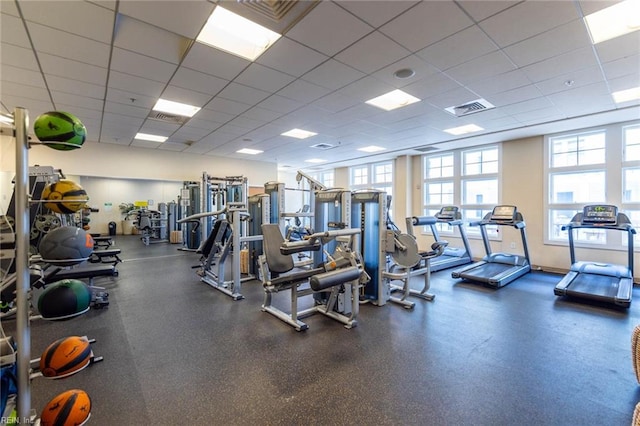 exercise room with a paneled ceiling