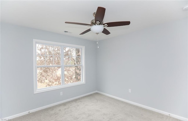 carpeted empty room featuring ceiling fan