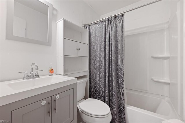 full bathroom featuring shower / bathtub combination with curtain, vanity, and toilet