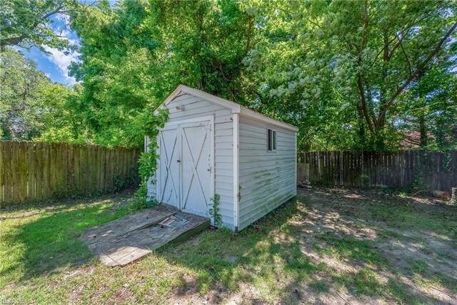 view of outbuilding with a lawn