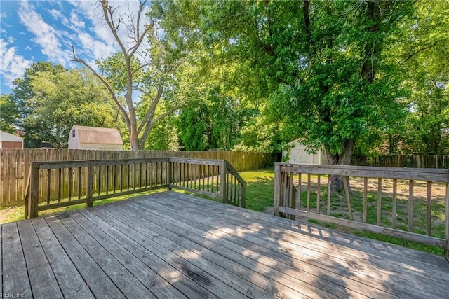 deck with a shed and a yard