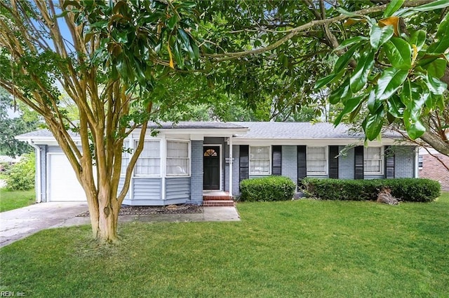 ranch-style home featuring a garage and a front lawn