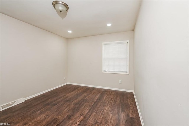 spare room with dark hardwood / wood-style flooring