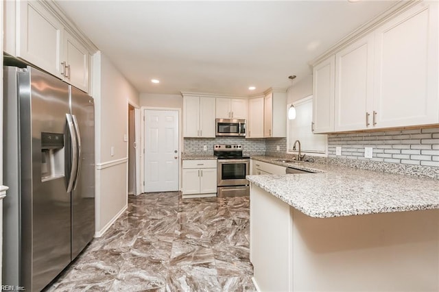 kitchen with hanging light fixtures, light stone counters, kitchen peninsula, stainless steel appliances, and sink