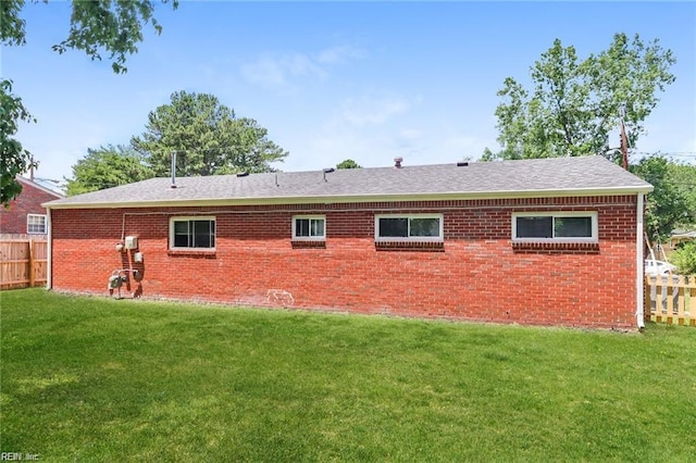 rear view of house featuring a lawn