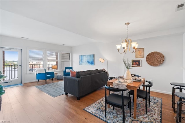 dining area featuring a notable chandelier and hardwood / wood-style floors